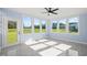 Sunroom with multiple windows, a door to the backyard and ceiling fan at 2804 Jack Mitchell Rd, Zebulon, NC 27597