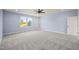 Spacious bedroom with grey carpet, built-in shelves and windows at 2804 Jack Mitchell Rd, Zebulon, NC 27597