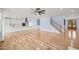 Open living room with hardwood floors, a ceiling fan, and staircase at 2804 Jack Mitchell Rd, Zebulon, NC 27597
