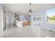 Bright kitchen with island, white cabinets, and views from the window at 2804 Jack Mitchell Rd, Zebulon, NC 27597