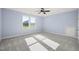 Bright bedroom with carpet flooring and large windows at 2804 Jack Mitchell Rd, Zebulon, NC 27597