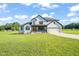 Two-story farmhouse with white siding, black accents, and a large yard at 2804 Jack Mitchell Rd, Zebulon, NC 27597
