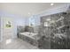 Bathroom with soaking tub, walk-in shower, and marble tile at 2804 Jack Mitchell Rd, Zebulon, NC 27597