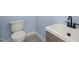 Small bathroom with white toilet and sink, and dark fixtures at 2804 Jack Mitchell Rd, Zebulon, NC 27597