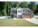 Two-story home with stone and shingle exterior at 159 Shady Oaks Dr, Benson, NC 27504