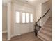 Bright entryway with wood-look floors, staircase, and a view into the living area at 159 Shady Oaks Dr, Benson, NC 27504
