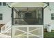 Relaxing screened porch with stone fireplace and ceiling fan at 159 Shady Oaks Dr, Benson, NC 27504