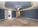Main bedroom with blue walls, tray ceiling, and access to en suite bath at 159 Shady Oaks Dr, Benson, NC 27504