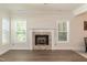 Living room with a modern stone fireplace and hardwood floors at 159 Shady Oaks Dr, Benson, NC 27504