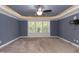 Main bedroom with blue walls, lighted tray ceiling, and neutral carpet at 159 Shady Oaks Dr, Benson, NC 27504