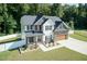 Two-story house with stone accents, a large yard, and a two-car garage at 159 Shady Oaks Dr, Benson, NC 27504