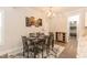 Formal dining room with hardwood floors, chandelier, and access to kitchen at 159 Shady Oaks Dr, Benson, NC 27504