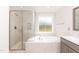 Elegant bathroom with soaking tub, shower, and double vanity at 159 Shady Oaks Dr, Benson, NC 27504