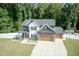 Two-story house with stone accents, a large yard, and a two-car garage at 159 Shady Oaks Dr, Benson, NC 27504