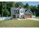 Two-story house with stone accents, a large yard, and a two-car garage at 159 Shady Oaks Dr, Benson, NC 27504