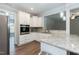 Modern kitchen with white cabinets, granite countertops, and stainless steel appliances at 159 Shady Oaks Dr, Benson, NC 27504