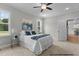 Comfortable bedroom with window, ceiling fan and view of backyard at 95 Weathered Oak Way, Youngsville, NC 27596