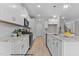 Bright kitchen featuring white cabinets, granite countertops and hardwood floors at 95 Weathered Oak Way, Youngsville, NC 27596