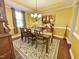 Formal dining room with hardwood floors, chandelier, and decorative wall art at 6424 Sunset Manor Dr, Wake Forest, NC 27587