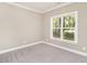 Simple bedroom with neutral carpeting and large window at 2074 Burch Bridge Rd, Burlington, NC 27217