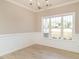Bright dining room with wainscoting and hardwood floors at 2074 Burch Bridge Rd, Burlington, NC 27217