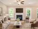 Living room boasts a fireplace, hardwood floors and comfy seating at 2074 Burch Bridge Rd, Burlington, NC 27217