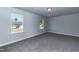 Unfurnished bedroom with gray carpet, white walls, and large windows at 42 Decatur Dr, Fuquay Varina, NC 27526