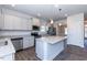 Spacious kitchen with gray cabinets, pendant lights, and access to a pantry at 56 Decatur Dr, Fuquay Varina, NC 27526