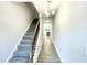 Bright foyer with a carpeted staircase, wood-look flooring, and a view into the kitchen at 66 Decatur Dr, Fuquay Varina, NC 27526