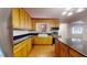 Bright kitchen features golden cabinets, granite counters, and a farmhouse sink at 5141 Nc 56, Franklinton, NC 27525