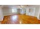 Living room with hardwood floors, built-in shelving, and large windows at 5141 Nc 56, Franklinton, NC 27525