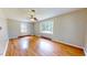 Hardwood floor bedroom with neutral walls and large windows at 5141 Nc 56, Franklinton, NC 27525