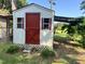 White shed with red door and windows at 5141 Nc 56, Franklinton, NC 27525