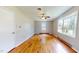 Bedroom with hardwood floors, large window, and ceiling fan at 5141 Nc 56, Franklinton, NC 27525