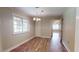 Bright dining room with hardwood floors and view into adjacent room at 5141 Nc 56, Franklinton, NC 27525