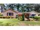 Ranch home with a well-manicured lawn and mature trees at 5141 Nc 56, Franklinton, NC 27525
