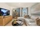Relaxing Gathering room featuring a large sectional sofa, a media console, and a stylish bookshelf at 6421 Alfalfa Ln, Wake Forest, NC 27587