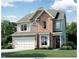 Two-story brick home with a two-car garage and landscaped yard at 7713 Litcham Dr, Raleigh, NC 27615