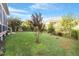 Landscaped backyard with lush grass and a variety of trees at 409 Swift Creek Xing, Durham, NC 27713