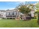 Home's back exterior with a screened porch and hot tub at 409 Swift Creek Xing, Durham, NC 27713