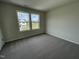 Spacious bedroom with neutral carpeting and dual windows at 80 Lotus Ave, Smithfield, NC 27577