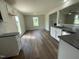 Open kitchen with granite countertops, white cabinets, and views into adjacent living space at 80 Lotus Ave, Smithfield, NC 27577
