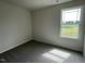 Cozy carpeted bedroom with a large window offering natural light at 80 Lotus Ave, Smithfield, NC 27577