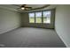 Large main bedroom with ceiling fan, carpet, and expansive windows at 80 Lotus Ave, Smithfield, NC 27577
