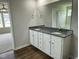 Double vanity bathroom with granite countertops and a large mirror at 80 Lotus Ave, Smithfield, NC 27577