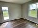 Bright bedroom with wood-look flooring and access to a patio at 80 Lotus Ave, Smithfield, NC 27577