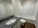 Bathroom with a bathtub, toilet and granite countertop at 80 Lotus Ave, Smithfield, NC 27577