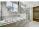 Luxurious bathroom featuring a soaking tub, glass shower, and marble tile at 170 Aberdeen, Rocky Mount, NC 27804