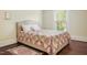 Bedroom with a beige upholstered bed frame and hardwood floors at 1502 Bahama Rd, Bahama, NC 27503