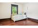 Small bedroom with a white bed frame and hardwood floors at 1502 Bahama Rd, Bahama, NC 27503